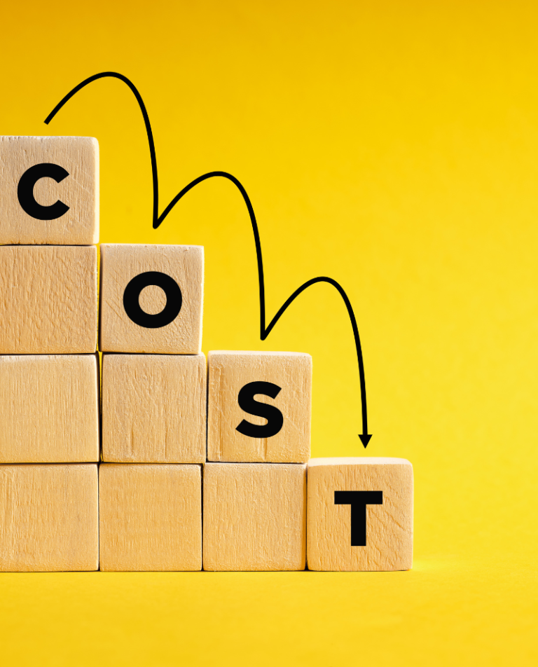 Wooden blocks spelling COST with downward arrows, symbolizing affordable dental implant pricing at Anata Dental Clinic in Kanata.