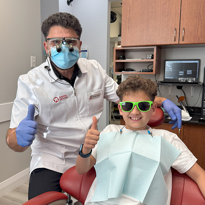 Children’s Dentist in Kanata gently caring for a young patient at Anata Dental Clinic.
